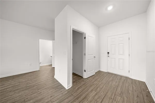 a view of a hallway with wooden floor