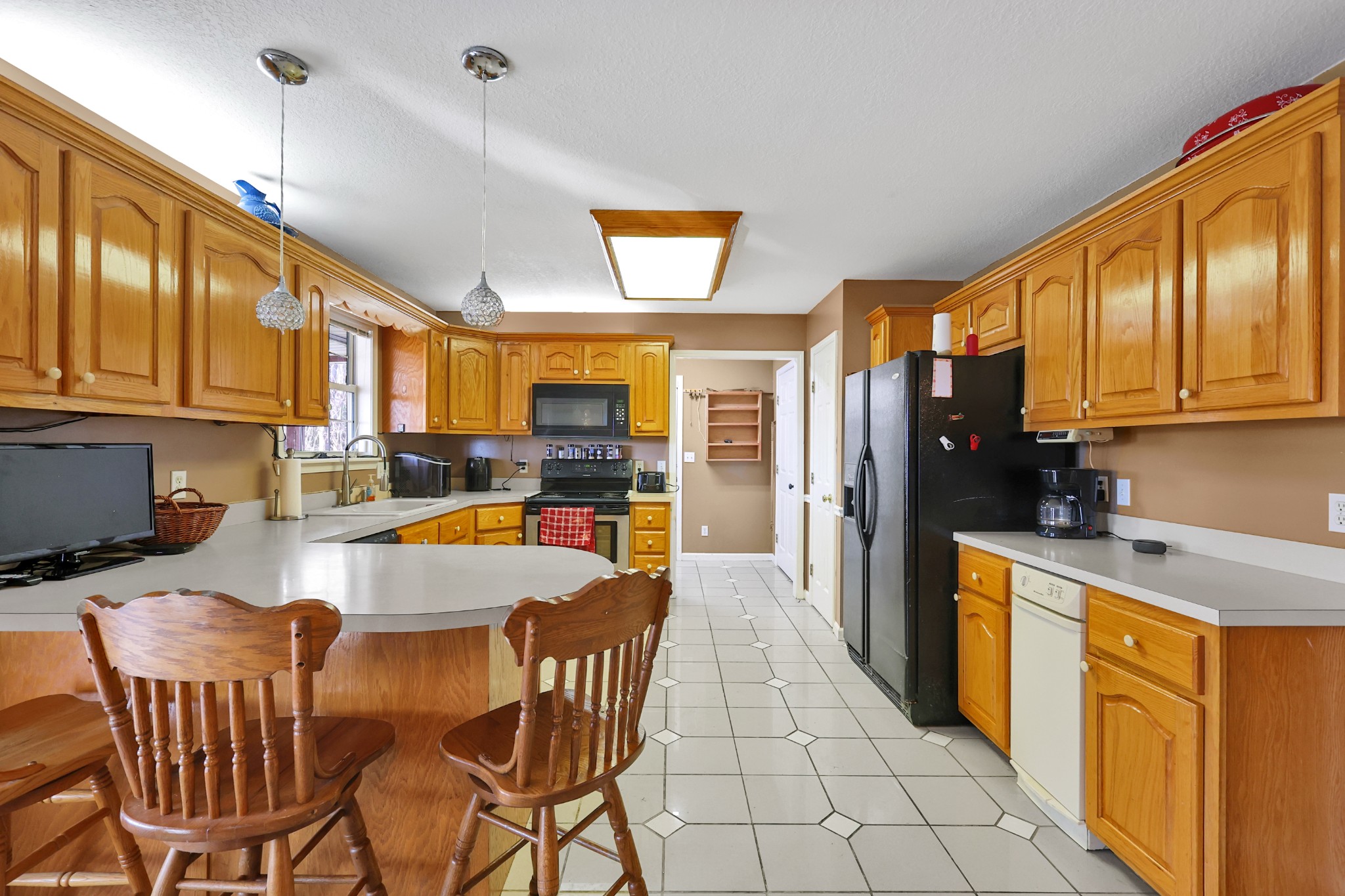 126 4th Avenue North Baxter, TN 38544 - Photo 12 of 33 a kitchen with stainless steel appliances granite countertop a refrigerator a stove top oven and a sink with cabinets