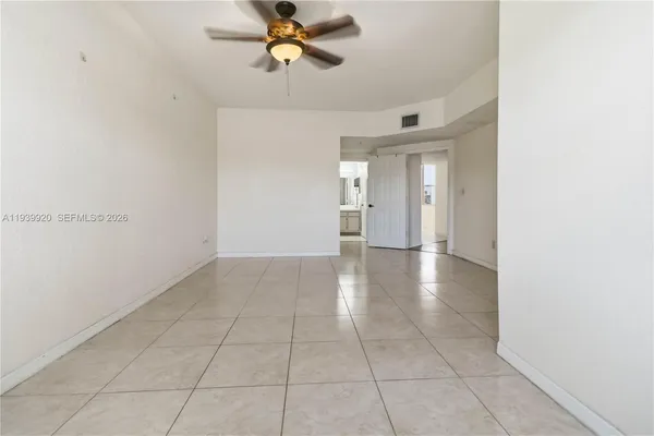 a view of a livingroom with a ceiling fan and window