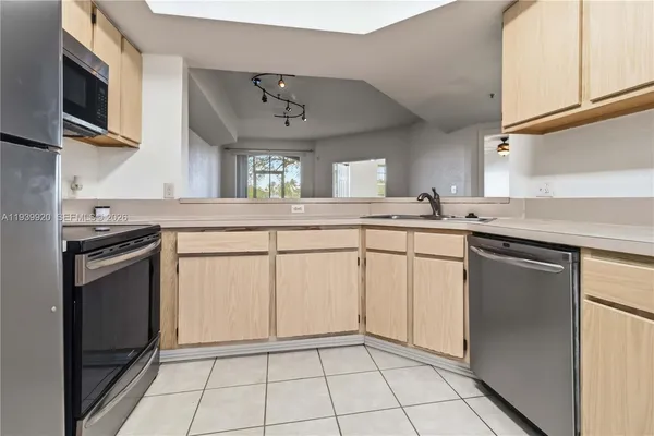 a kitchen with stainless steel appliances granite countertop a sink stove and microwave