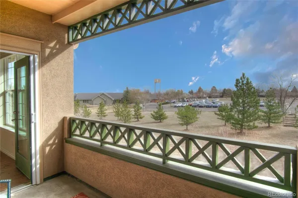 a view of a balcony with furniture and city view