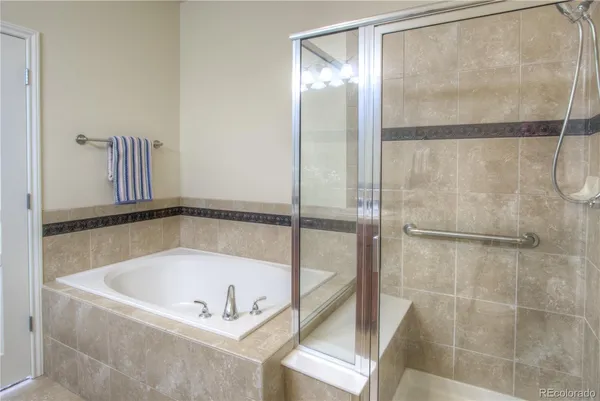 a bathroom with a tub and a shower