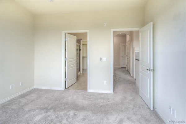 a view of a hallway with closet and wooden floor