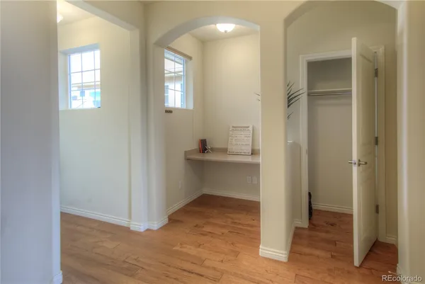 a view of a room with wooden floor and a bathroom