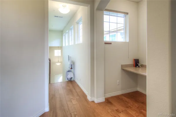 a view of hallway with wooden floor