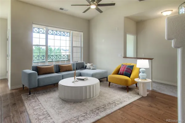 a living room with furniture and a large window