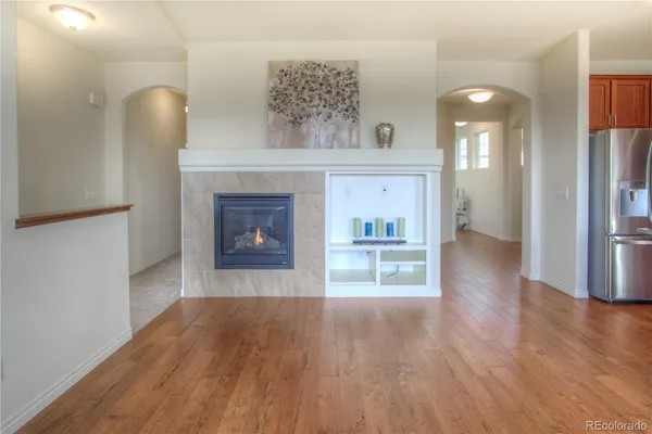 a view of a hallway with wooden floor and a fireplace