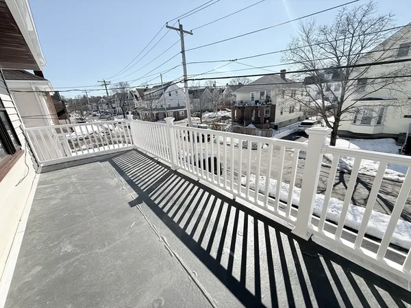 a view of a balcony with car parked