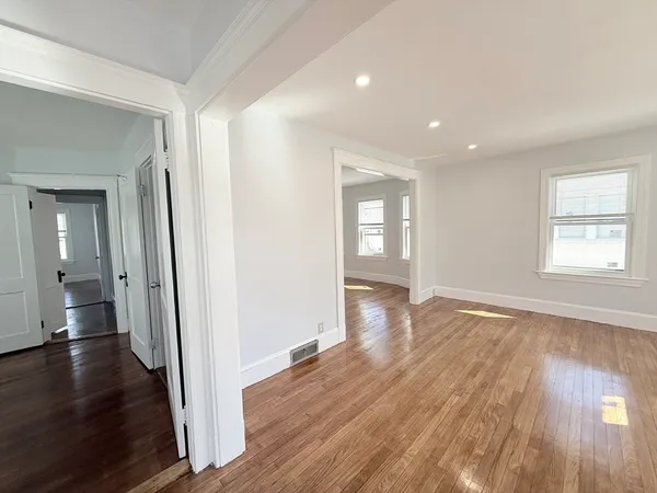 wooden floor in an empty room with windows and wooden floor