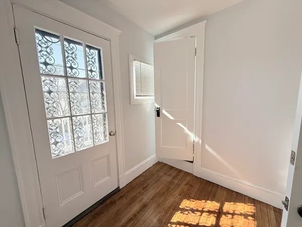 a view of an entryway with wooden floor