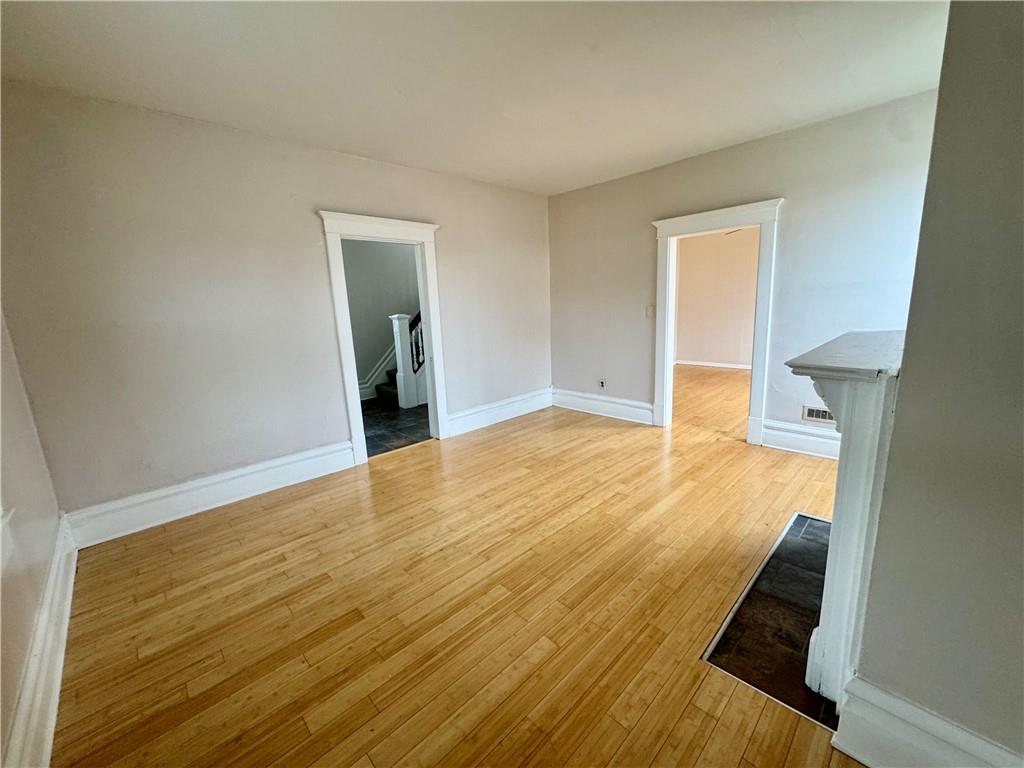 402 Cyrus Street Point Marion, PA 15474 - Photo 11 of 38 a view of an empty room with wooden floor and a window