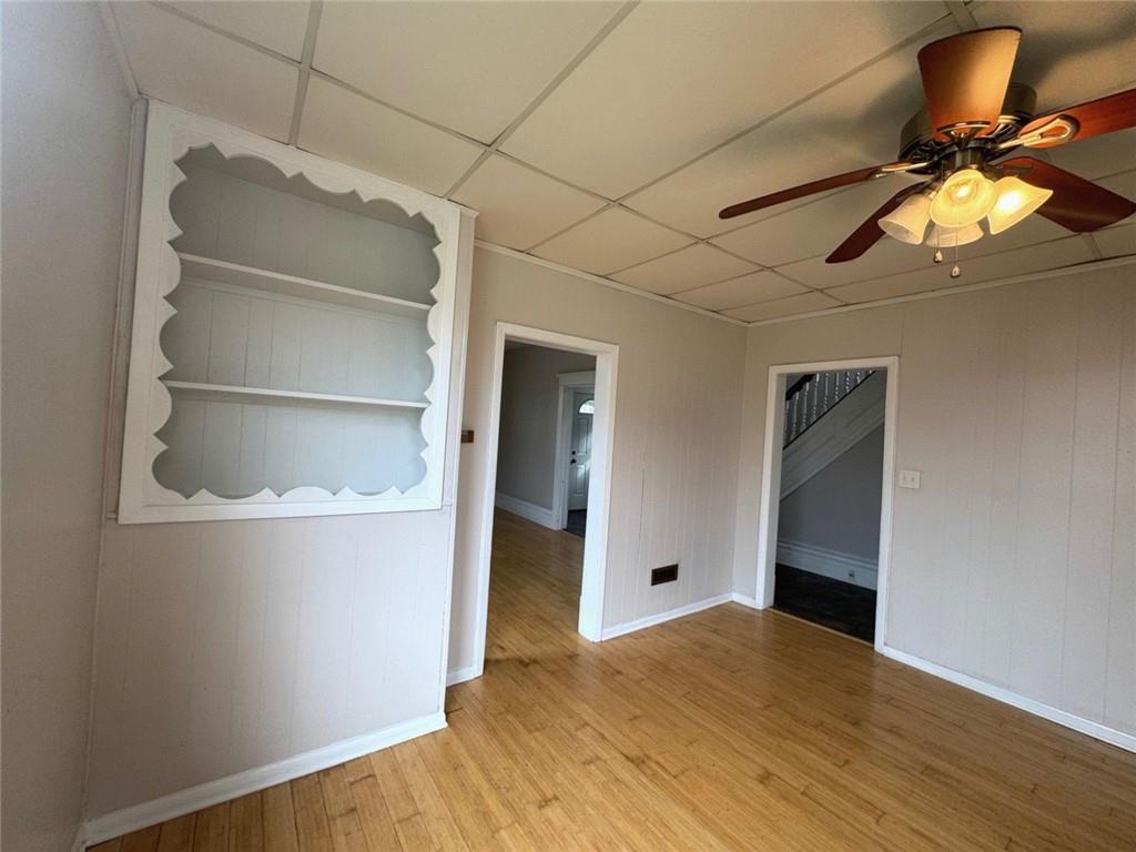 402 Cyrus Street Point Marion, PA 15474 - Photo 14 of 38 a view of empty room with wooden floor and fan