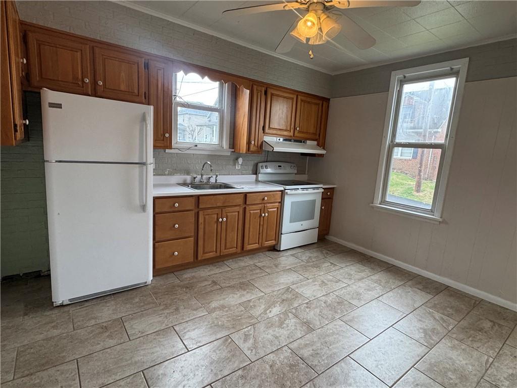402 Cyrus Street Point Marion, PA 15474 - Photo 17 of 38 a kitchen with stainless steel appliances granite countertop a refrigerator a sink a stove a microwave oven with white cabinets and countertops