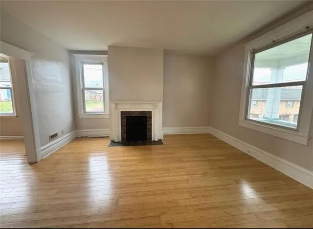 a kitchen with stainless steel appliances granite countertop a refrigerator a sink a stove a microwave oven with white cabinets and countertops