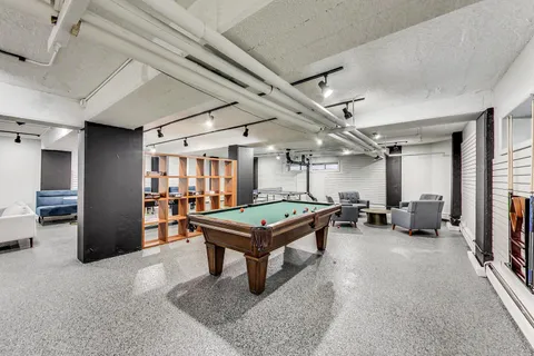 a room with furniture and air hockey table