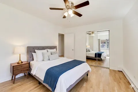 a bedroom with bed and a chandelier