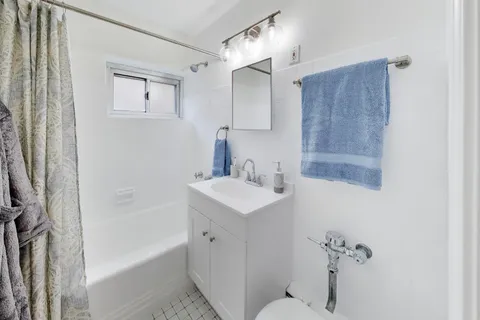 a bathroom with a sink toilet tub and shower