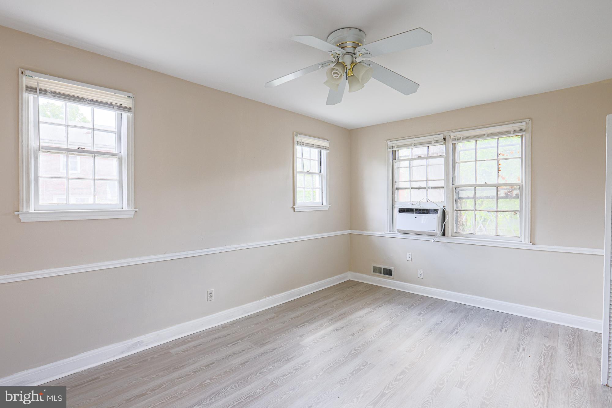 3914 Bancroft Road Baltimore, MD 21215 - Photo 9 of 25 a view of empty room with wooden floor and fan