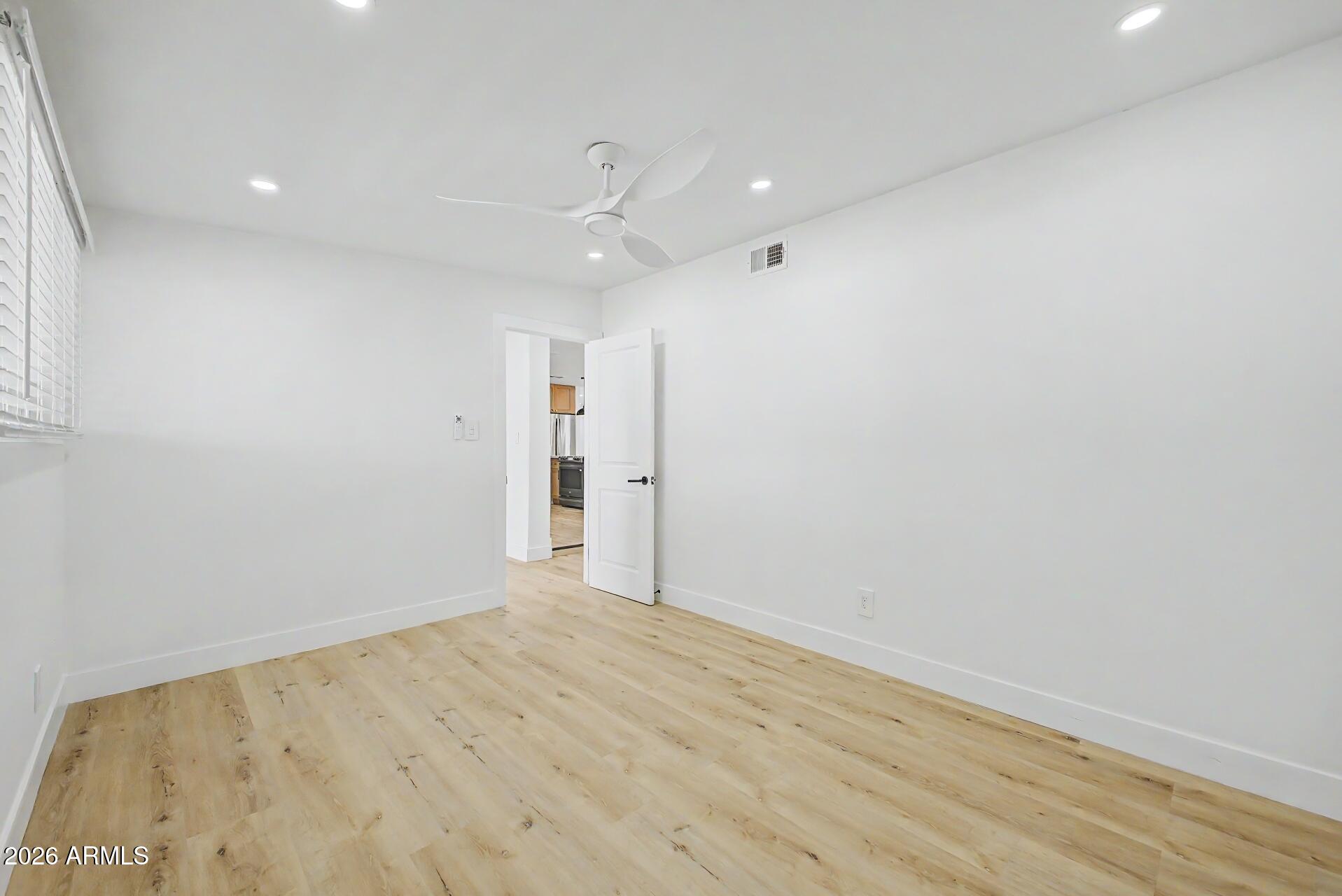 5232 West Hearn Road Glendale, AZ 85306 - Photo 20 of 32 an empty room with wooden floor
