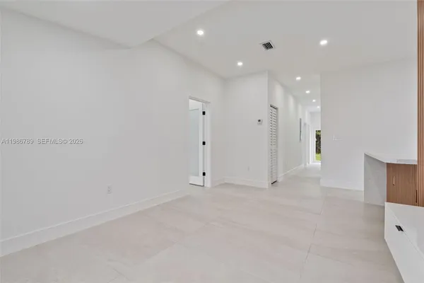 an empty room with a bathroom and a sink