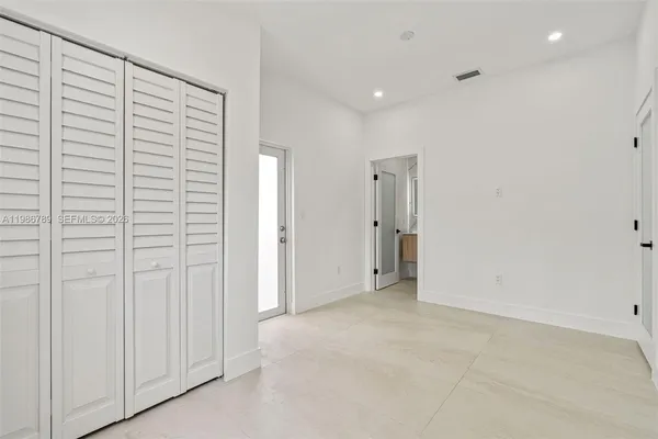 a view of a hallway with white walls