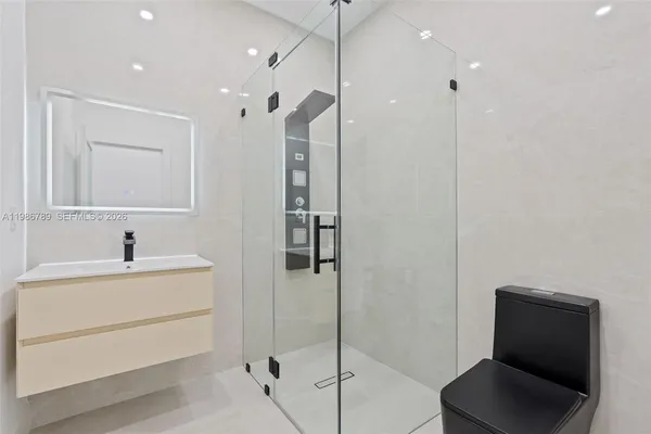 an empty room with windows and closet