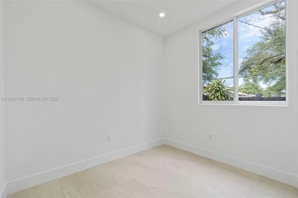 an empty room with a painting on the wall