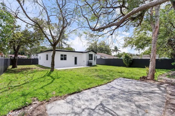 a view of a house with a backyard