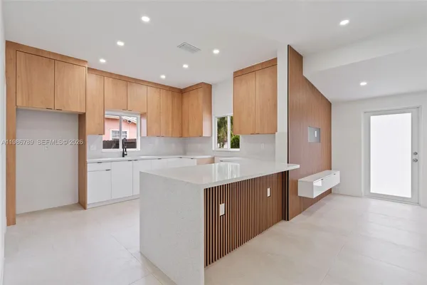 a kitchen with white cabinets and white appliances