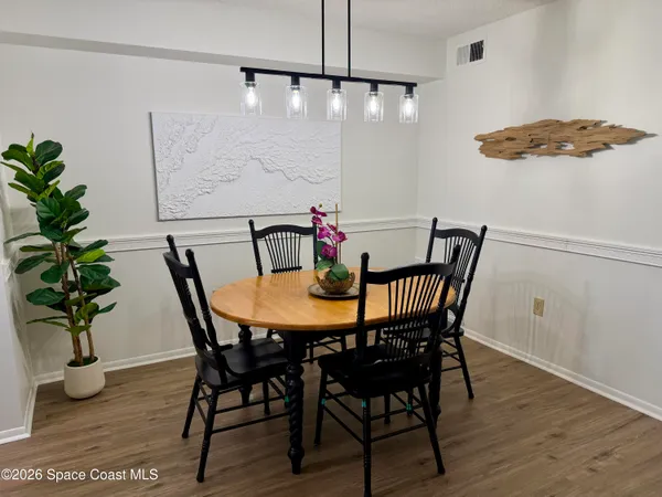 a view of a dining room with furniture window and wooden floor
