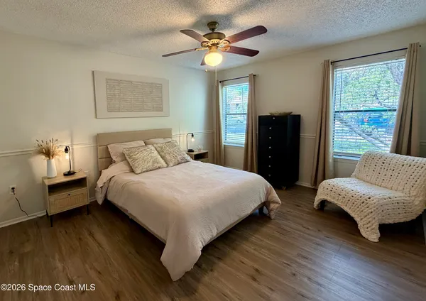 a bedroom with a bed and a couch