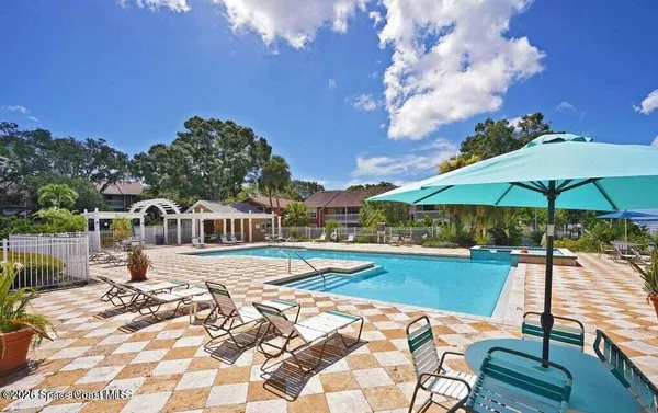 a view of a house with swimming pool and sitting area