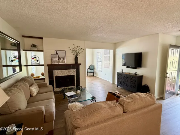 a living room with furniture flat screen tv and a fireplace