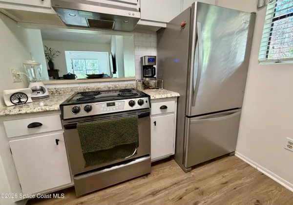 a kitchen with a stove and a refrigerator