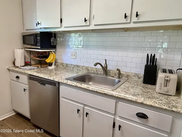 a kitchen with stainless steel appliances granite countertop a sink and cabinets