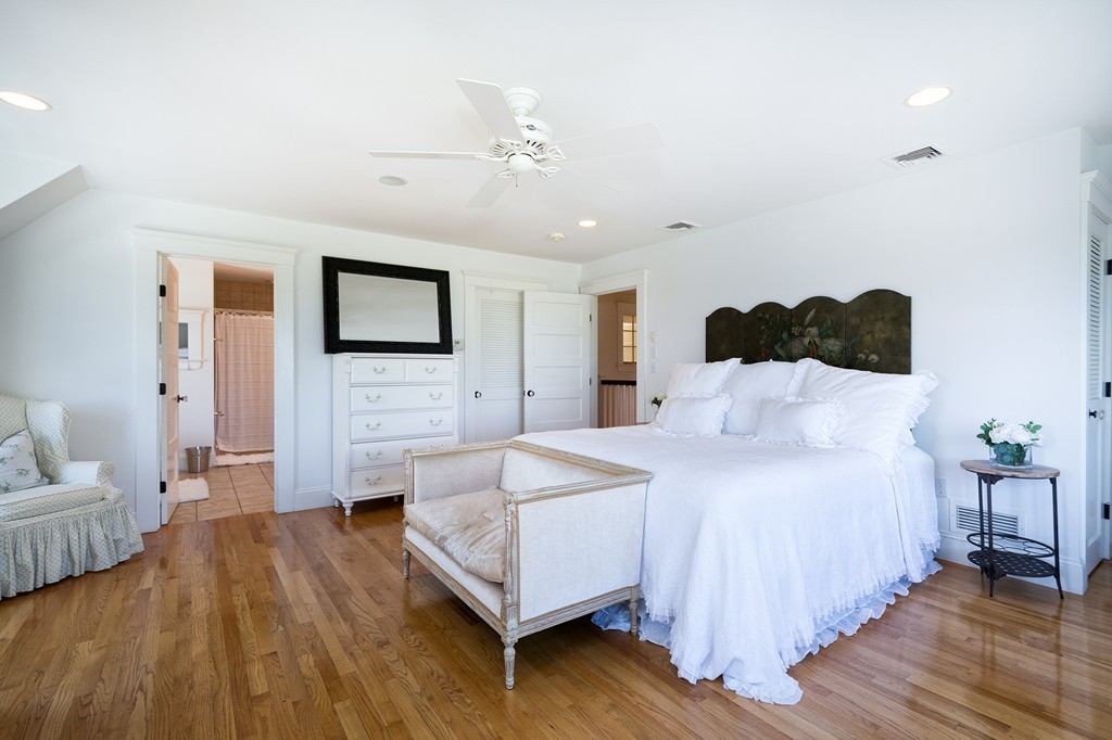 160 Edward Foster Road Scituate, MA 02066 - Photo 22 of 30 a spacious bedroom with a bed and a couch