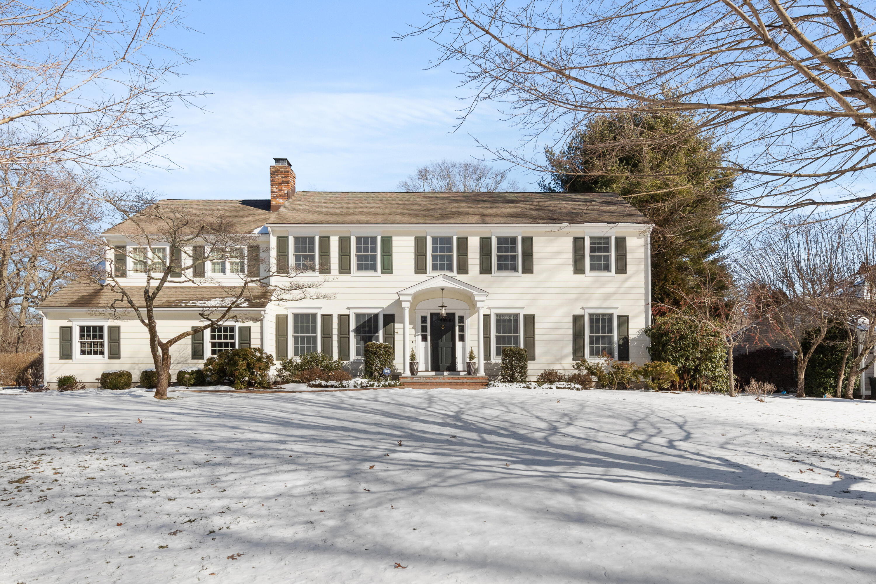 a front view of a residential apartment building with a yard