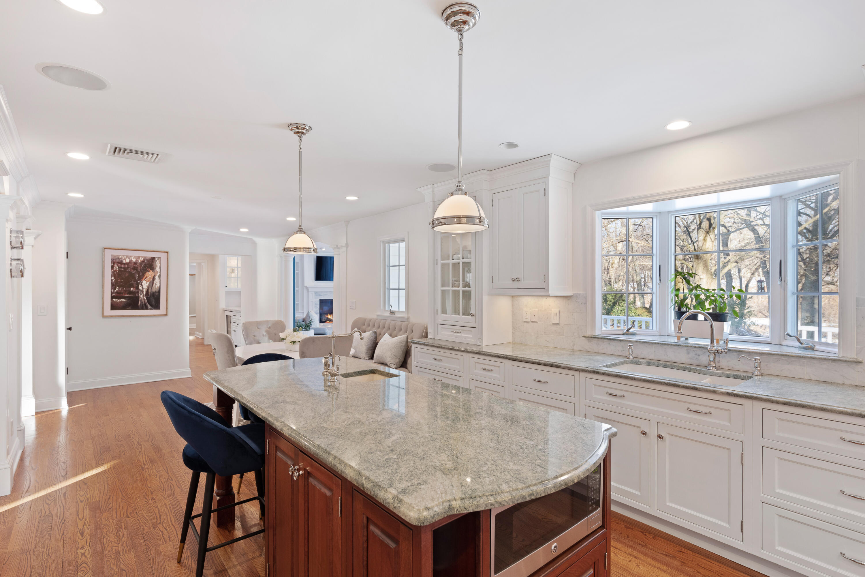 10 Chasmars Pond Road Darien, CT 06820 - Photo 11 of 32 a kitchen with center island table and chairs