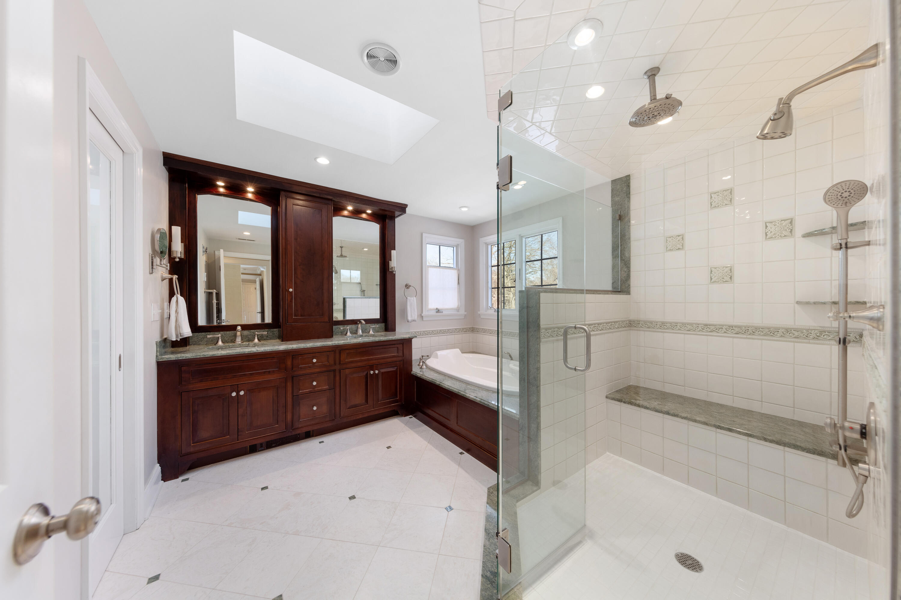 10 Chasmars Pond Road Darien, CT 06820 - Photo 19 of 32 a spacious bathroom with a tub sink shower and mirror