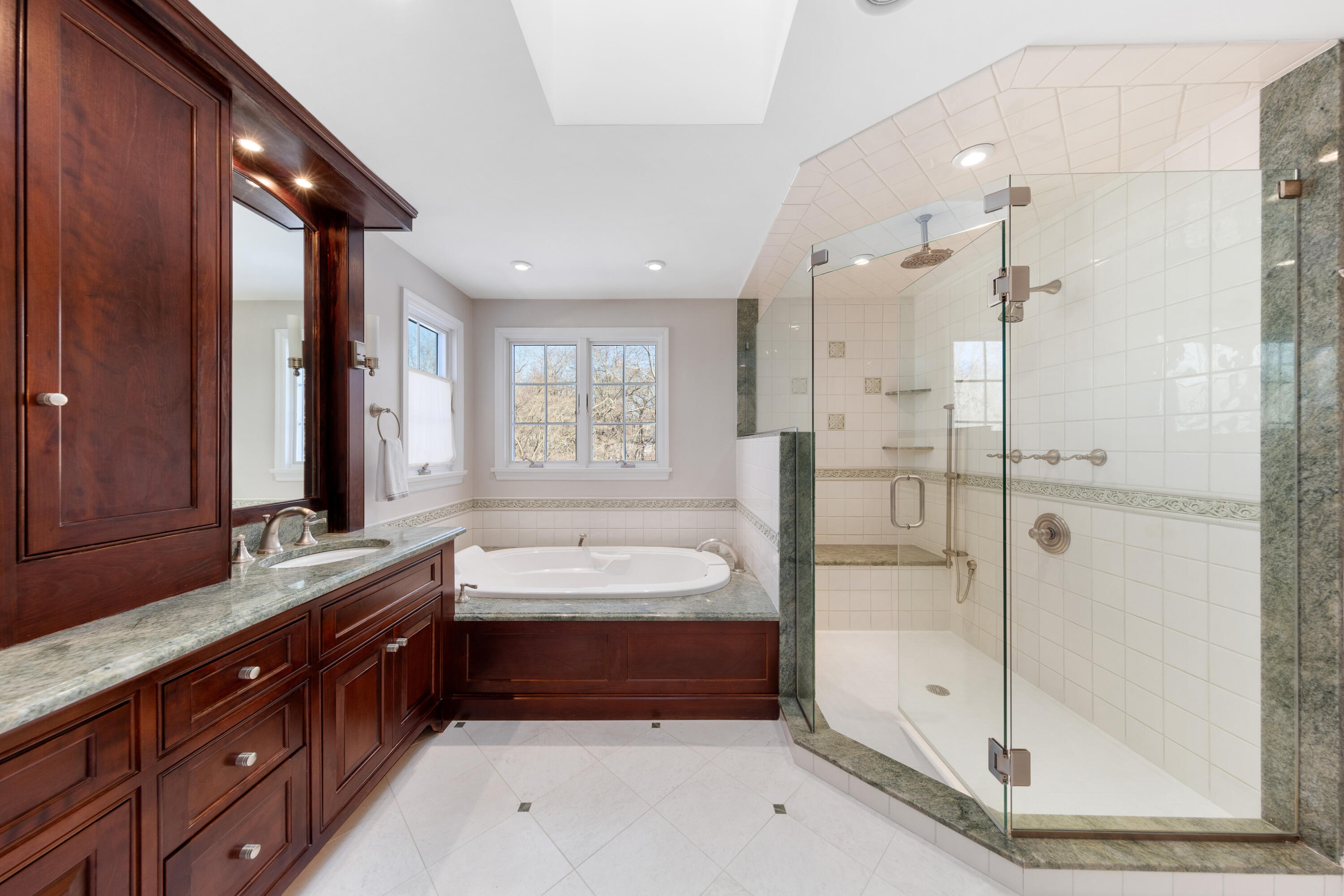 10 Chasmars Pond Road Darien, CT 06820 - Photo 20 of 32 a spacious bathroom with a double vanity sink and a mirror