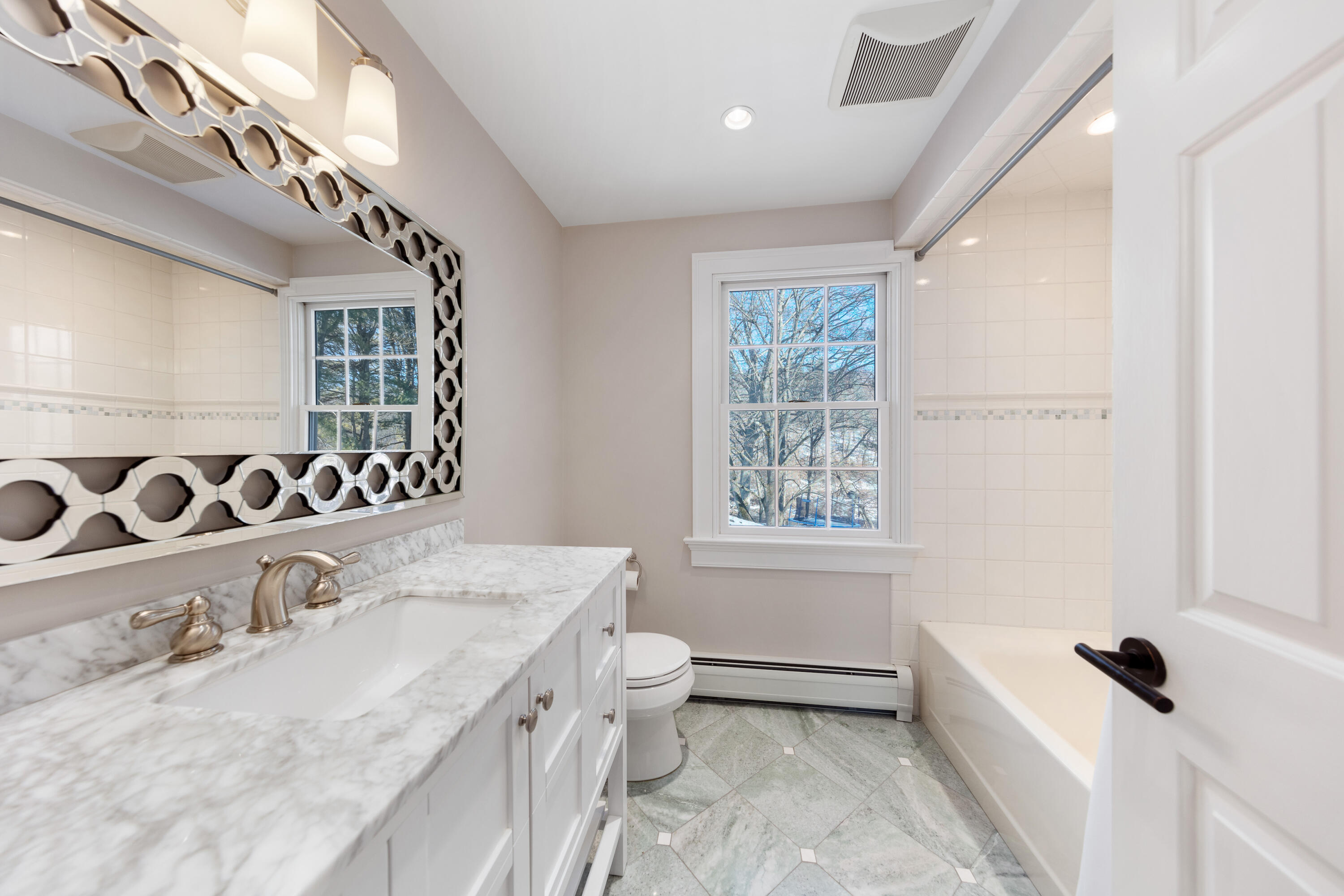 10 Chasmars Pond Road Darien, CT 06820 - Photo 24 of 32 a bathroom with a granite countertop sink a toilet and shower