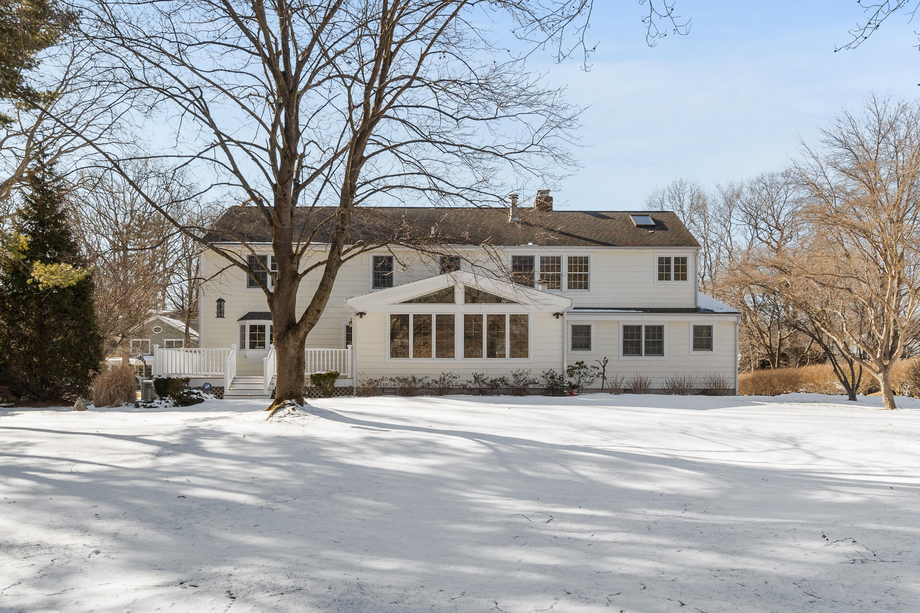 10 Chasmars Pond Road Darien, CT 06820 - Photo 27 of 32 a front view of residential houses with snow on the road