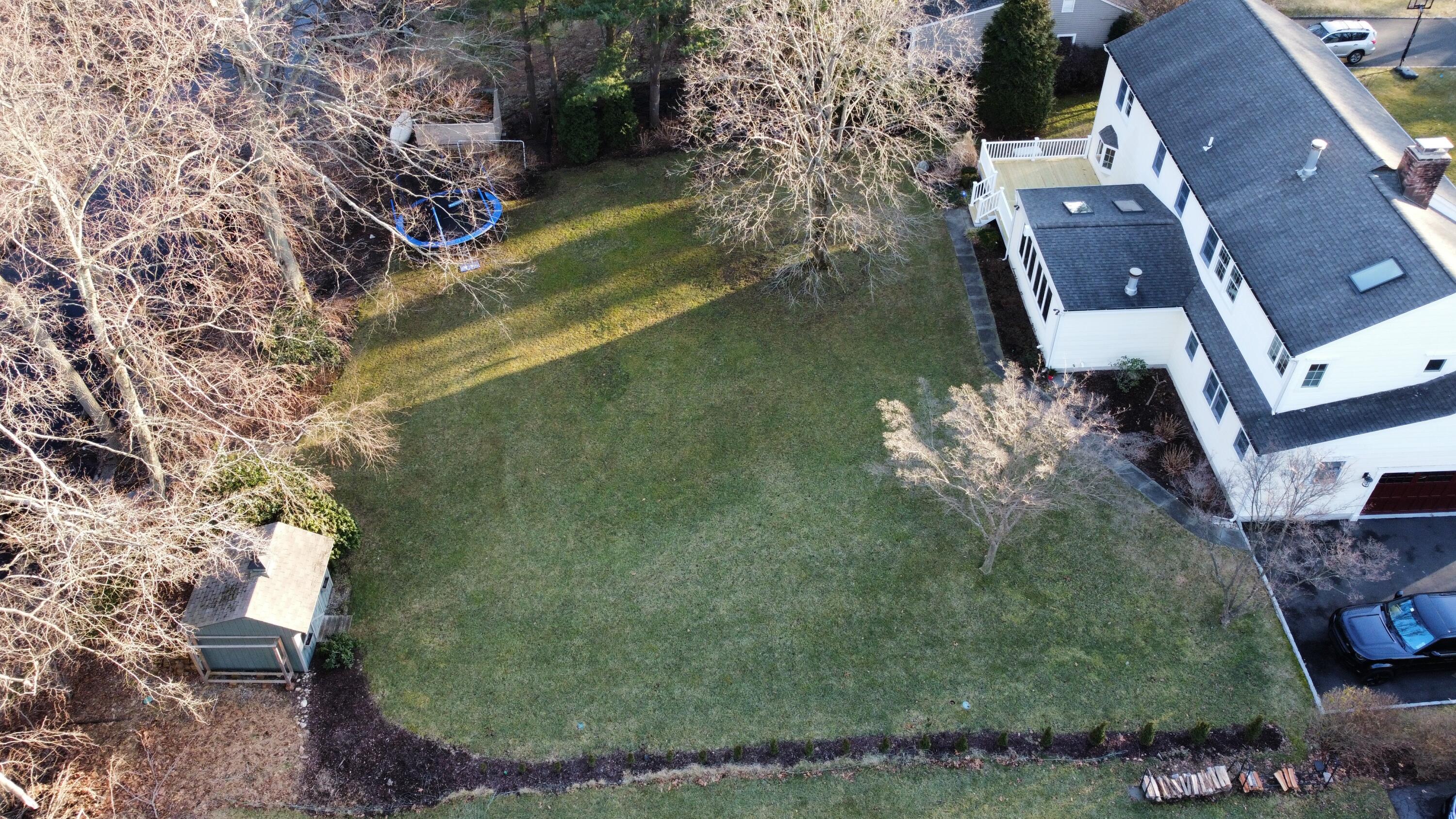 10 Chasmars Pond Road Darien, CT 06820 - Photo 29 of 32 an aerial view of a house with a yard