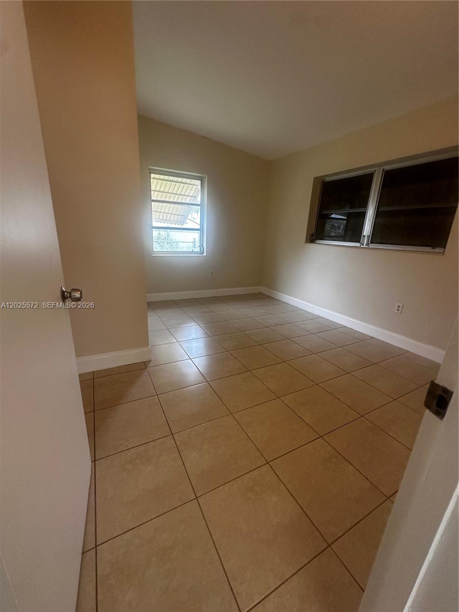 14475 Southwest 288th Street Homestead, FL 33033 - Photo 12 of 26 a view of a livingroom with an empty space and a window