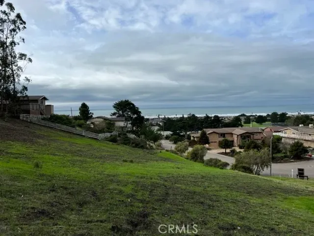 a view of a green field with sitting space