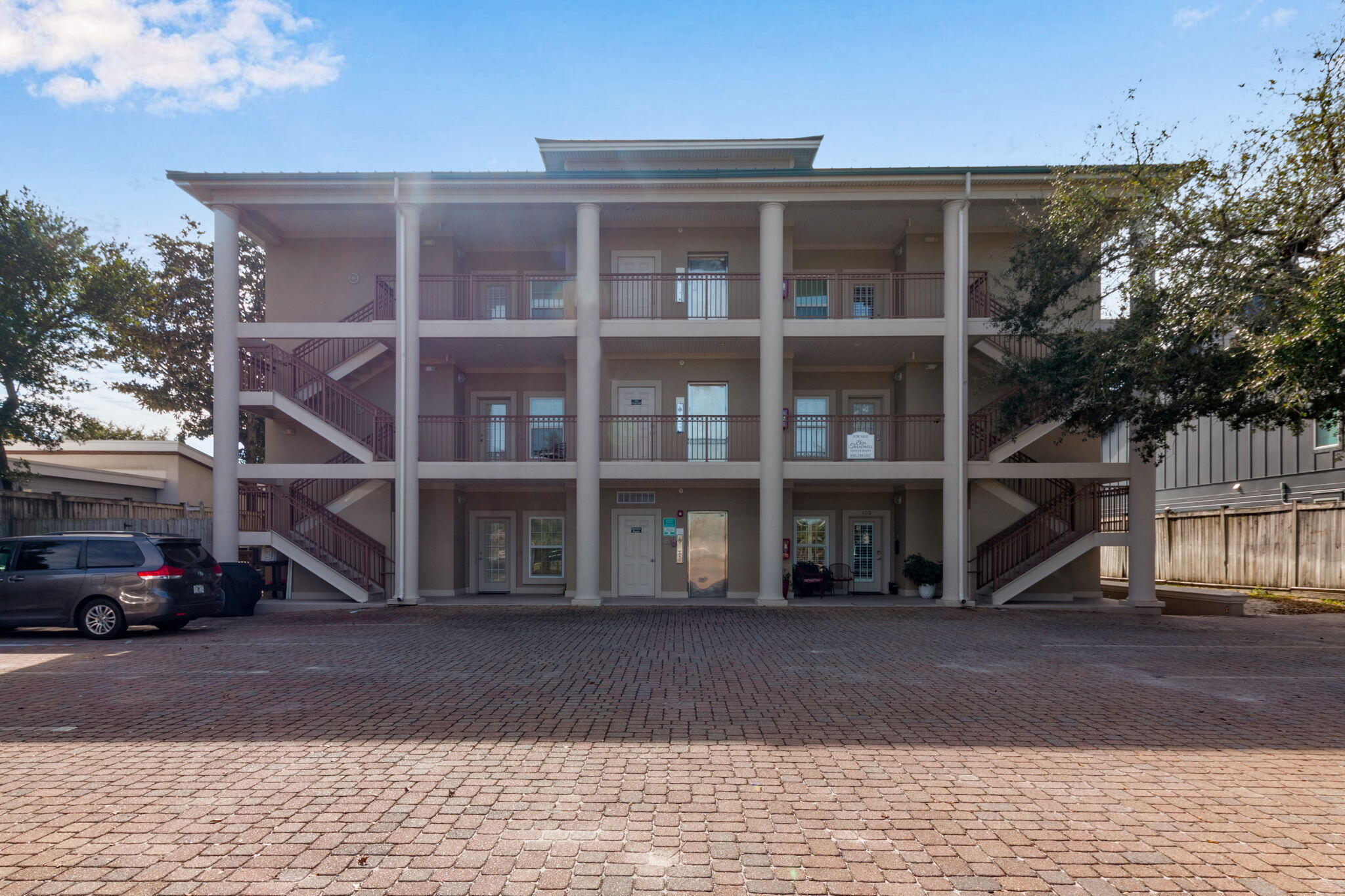 724 Harbor Boulevard, Unit 201 Destin, FL 32541 - Photo 1 of 25 a view of a building with a window and a car parked
