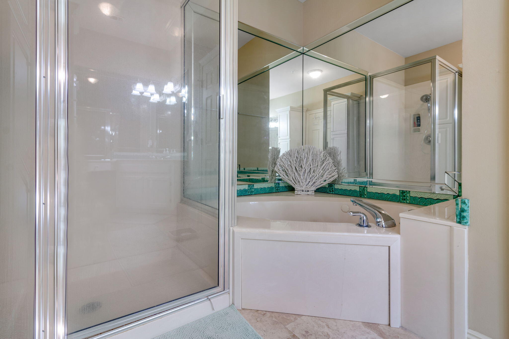 724 Harbor Boulevard, Unit 201 Destin, FL 32541 - Photo 13 of 25 a bathroom with a shower a mirror and a sink