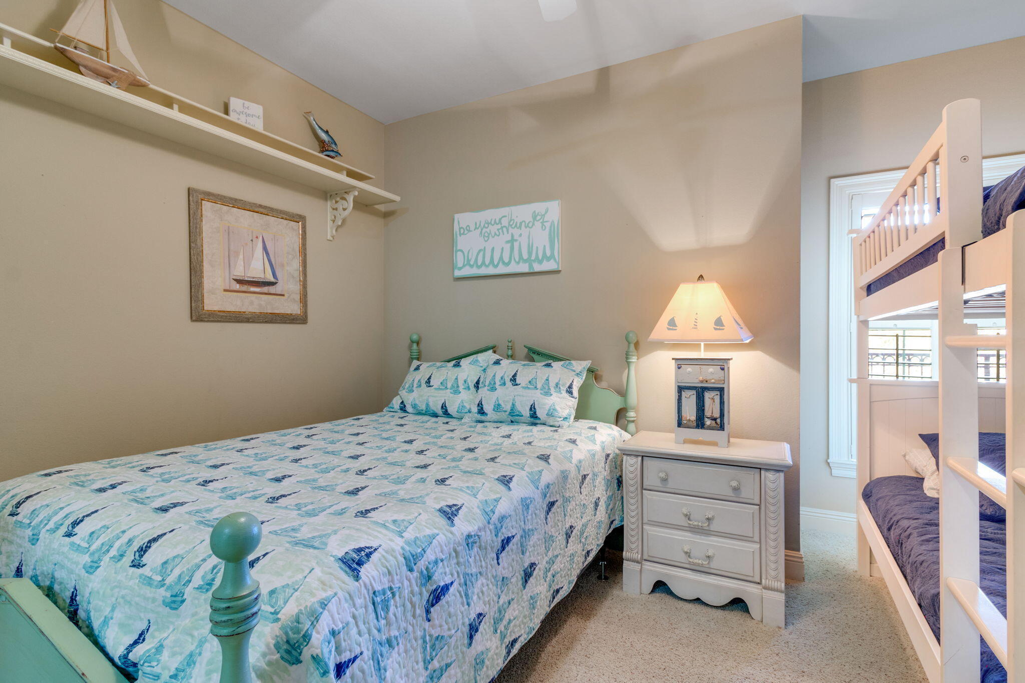 724 Harbor Boulevard, Unit 201 Destin, FL 32541 - Photo 21 of 25 a bedroom with a bed and a lamp