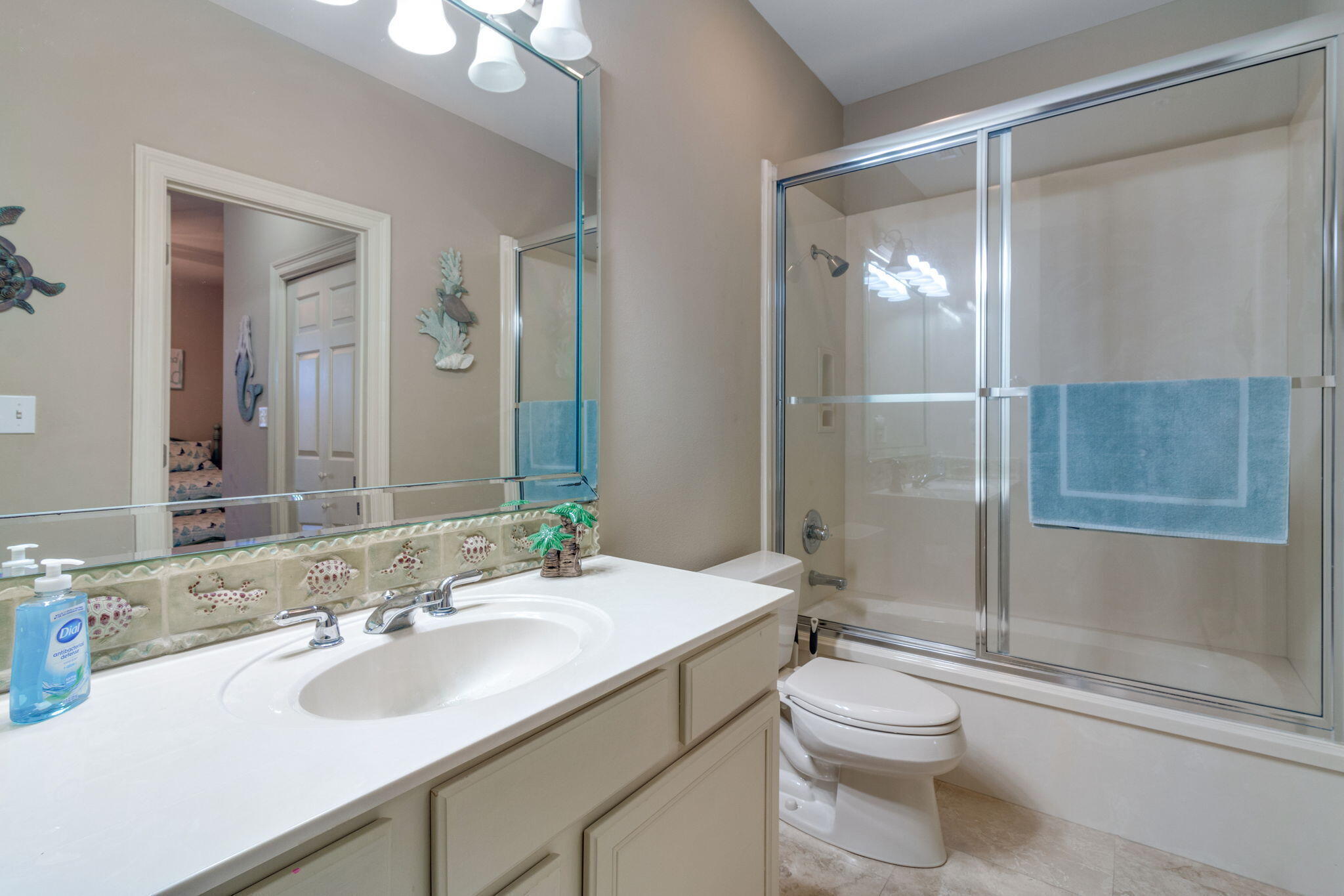724 Harbor Boulevard, Unit 201 Destin, FL 32541 - Photo 22 of 25 a bathroom with a sink toilet and shower