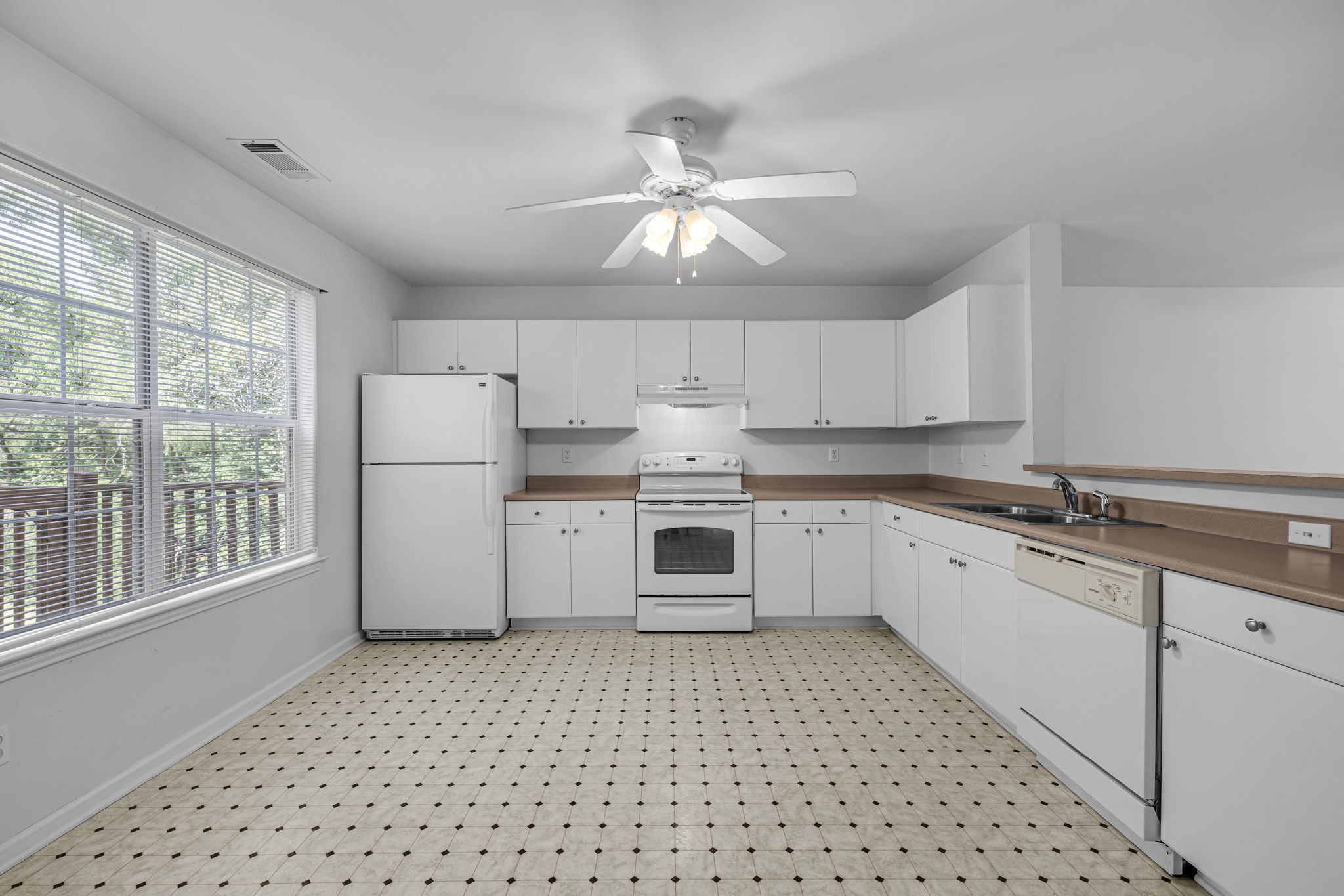 7334 Planters Road Fairview, TN 37062 - Photo 14 of 30 a kitchen with a white cabinets and white appliances